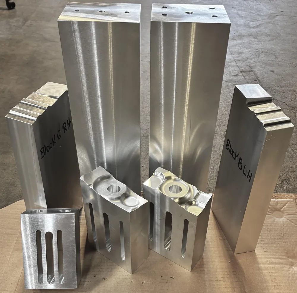Left- and right-hand CNC-milled aluminum blocks machined to matched tolerances at Carpatians Manufacturing in Troy, Michigan.